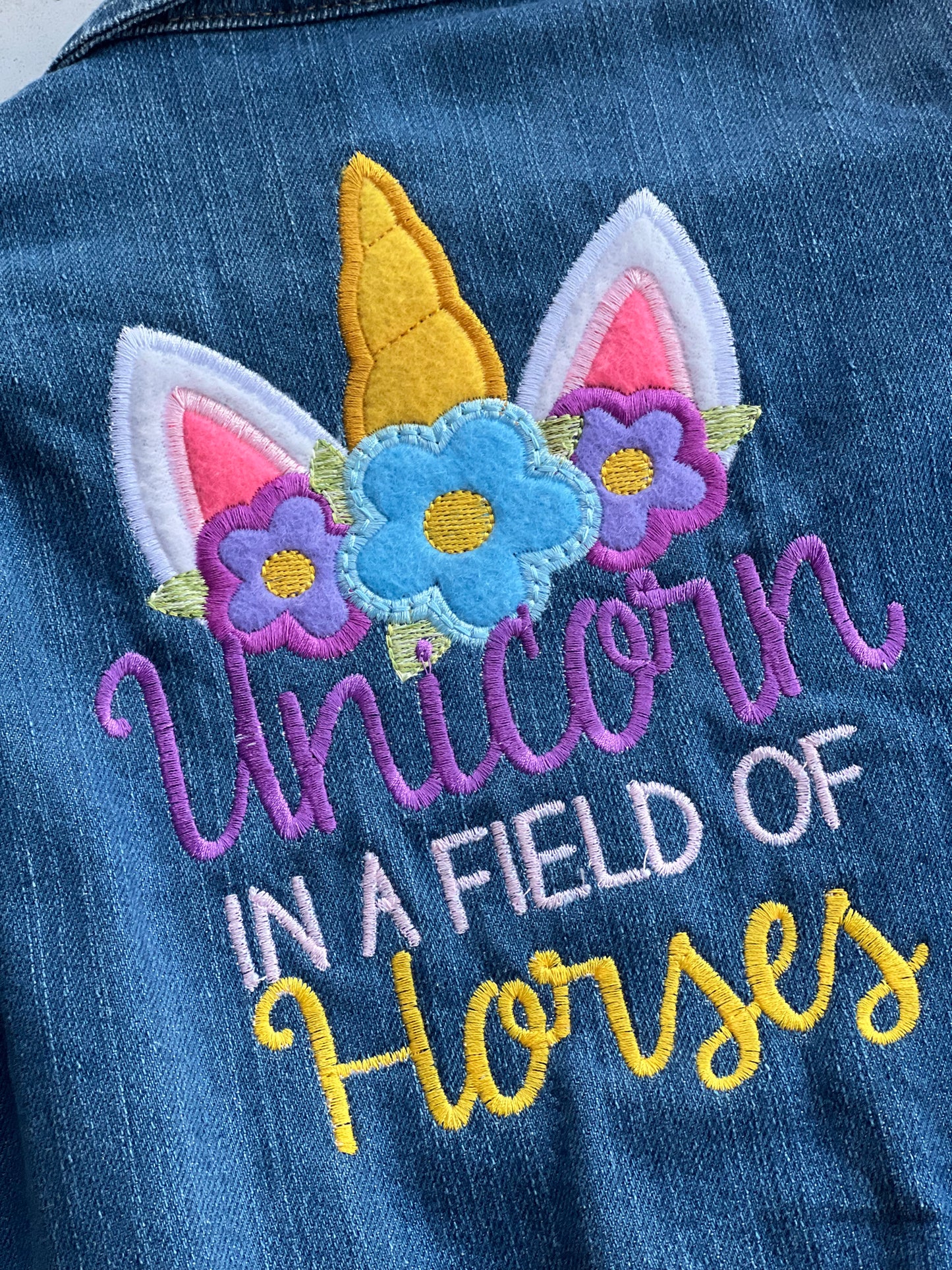 Unicorn in a field of horses Jean Jacket